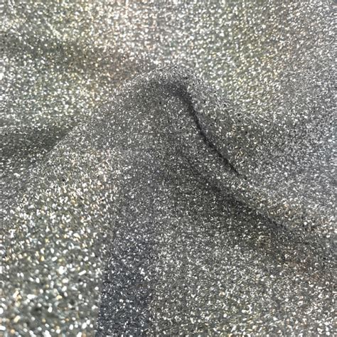 nubby fabric interwoven with glitter strands of silver metal|metallic shimmer fabric.